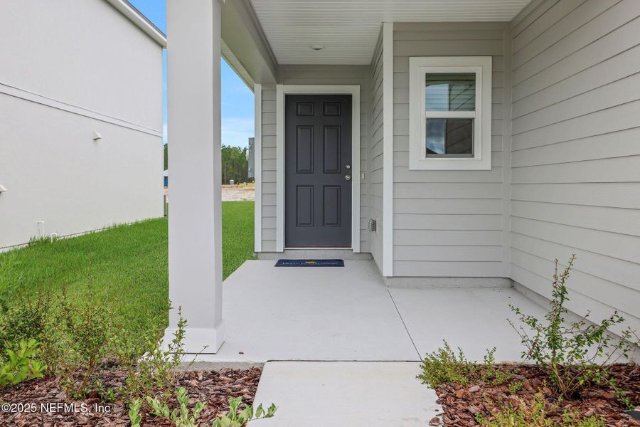 Front exterior of a new home in Bellbrooke, Jacksonville, FL, highlighting curb appeal (Image 13).