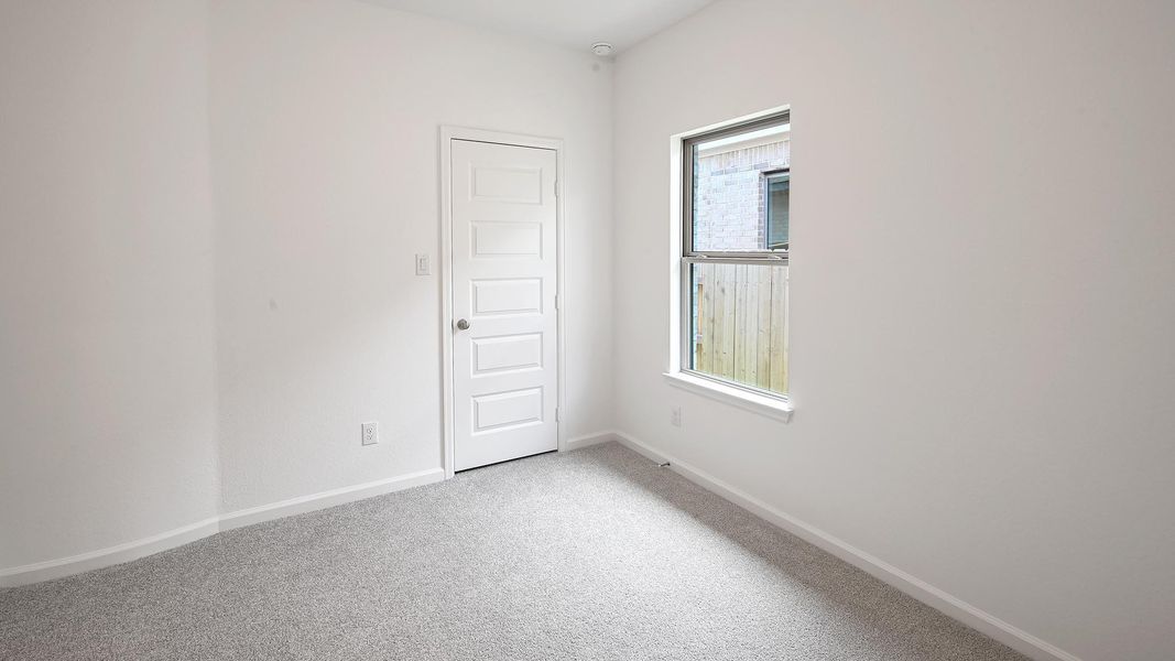Spare room featuring light carpet and baseboards Spare room featuring light carpet and baseboards