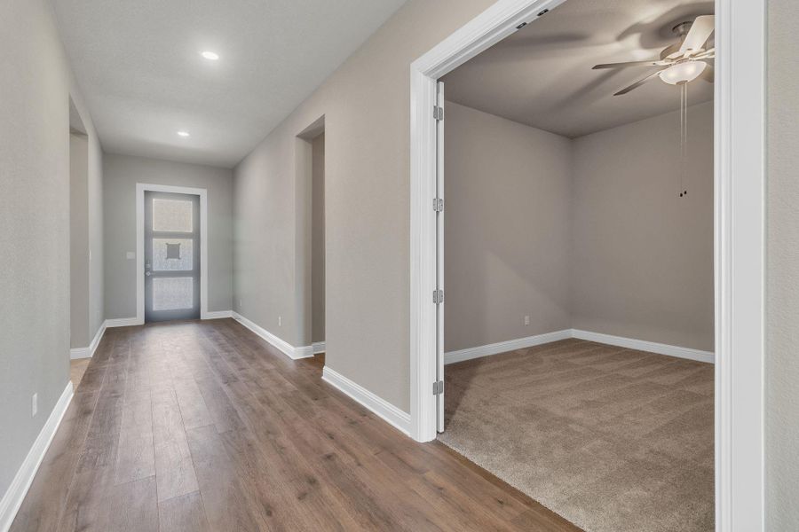 Foyer with light wood-type flooring, a ceiling fan, and recessed lighting