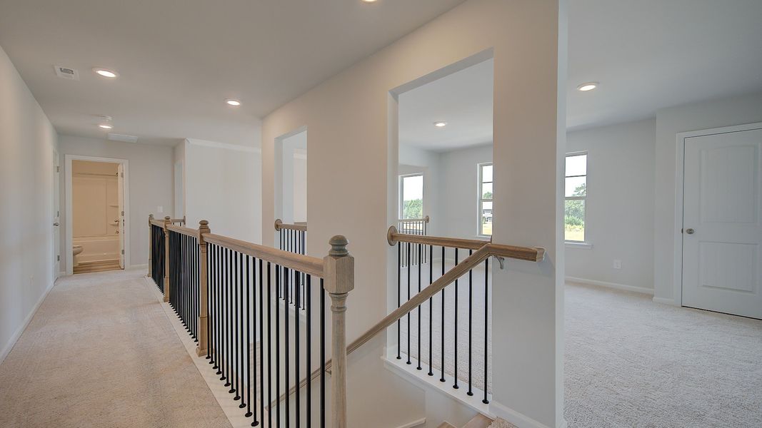 Clarity upstairs landing with carpet flooring and loft entry at Brighton in Locust Grove, GA.