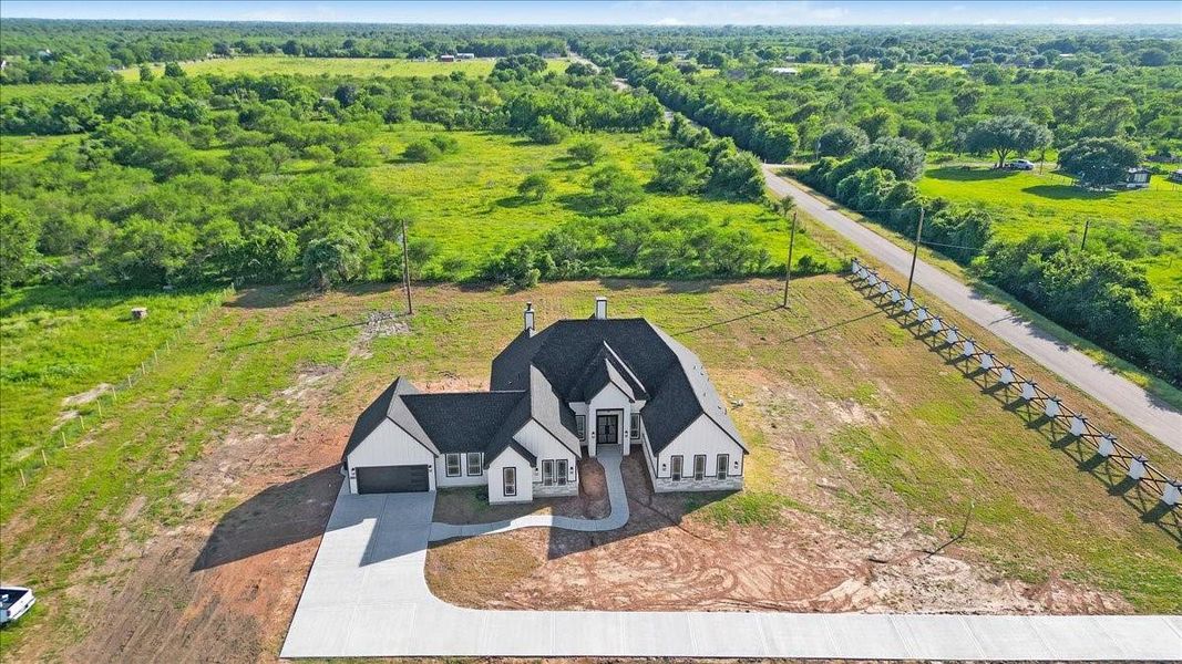 Elevated aerial view of the home showcasing the property layout and surrounding countryside. Elevated aerial view of the home showcasing the property layout and surrounding countryside.