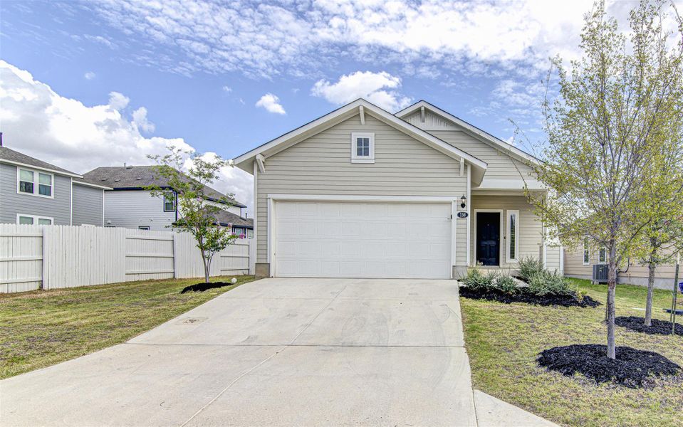 A welcoming front exterior showcasing a neatly paved driveway leading to an integrated garage. A welcoming front exterior showcasing a neatly paved driveway leading to an integrated garage.