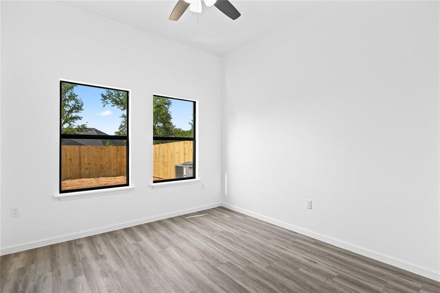 Spare room with hardwood / wood-style flooring and ceiling fan