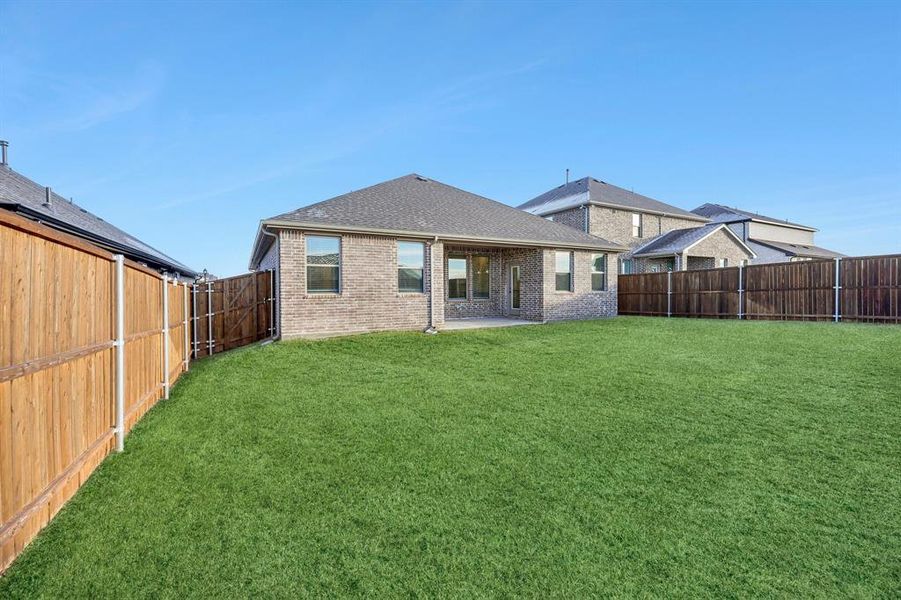 Back of property with a patio area and a yard