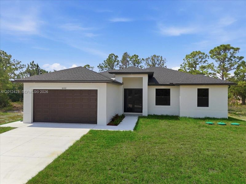 Front exterior of a new home in , Lehigh Acres, FL, highlighting curb appeal (Image 24).