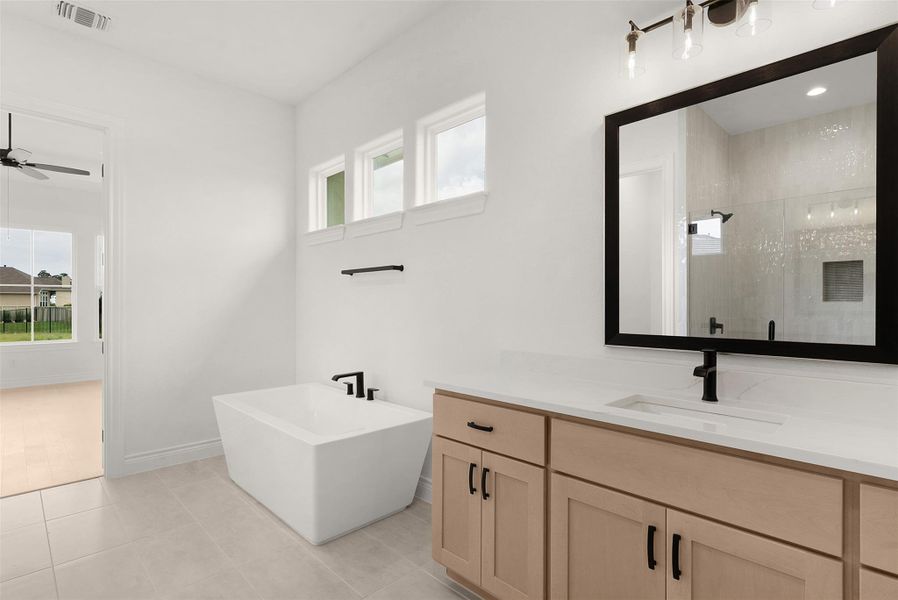 Luxurious bathroom with sleek modern fixtures and a freestanding soaking tub.