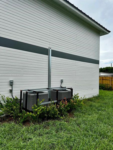 Front exterior of a new home in , Florida City, FL, highlighting curb appeal (Image 21). Front exterior of a new home in , Florida City, FL, highlighting curb appeal (Image 21).