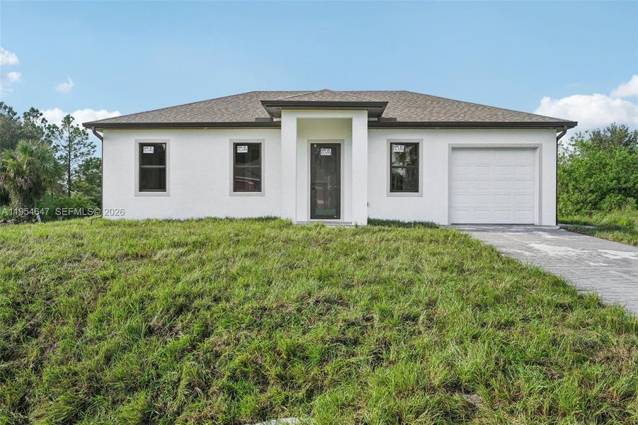 Front exterior of a new home in , Lehigh Acres, FL, highlighting curb appeal (Image 18).