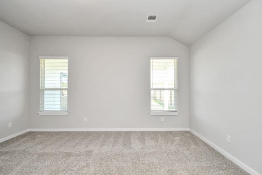 Escape to tranquility in this spacious primary room, adorned with plush carpeting and bathed in the soothing hues of warm paint colors, creating a cozy retreat for relaxation. Escape to tranquility in this spacious primary room, adorned with plush carpeting and bathed in the soothing hues of warm paint colors, creating a cozy retreat for relaxation.