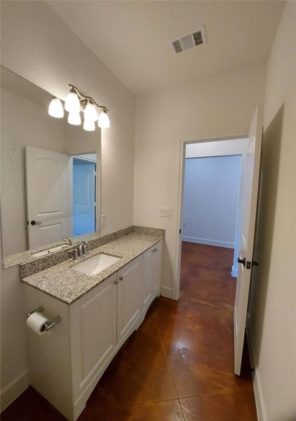 Bathroom with vanity and baseboards