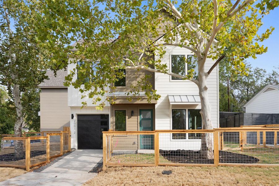 View of front of home with a fenced front yard, a gate, and an attached garage View of front of home with a fenced front yard, a gate, and an attached garage