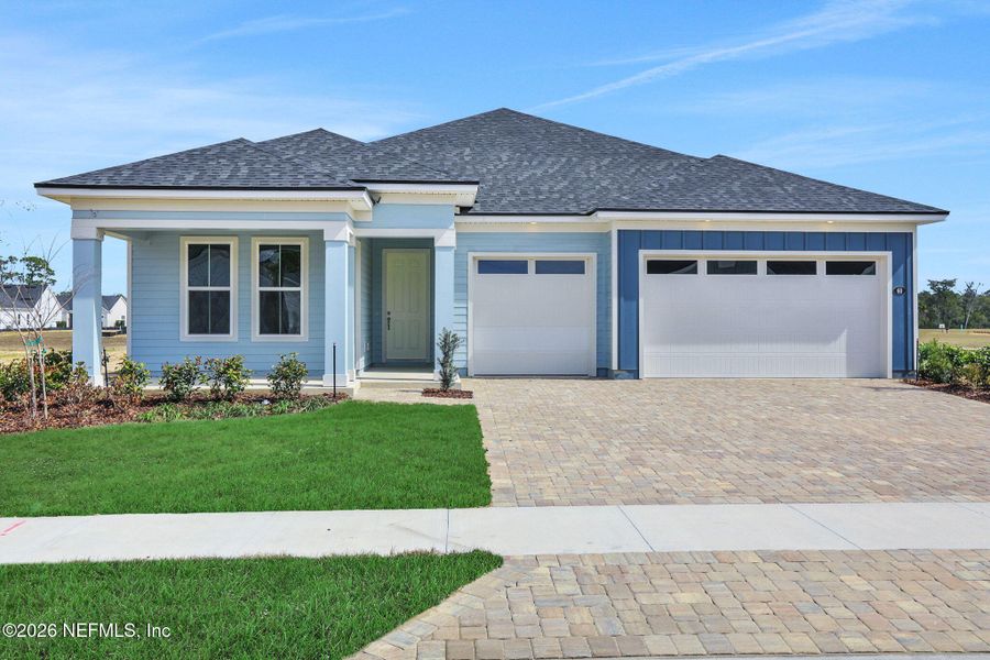 Front exterior of a new home in Veranda Bay, Flagler Beach, FL, highlighting curb appeal (Image 22).