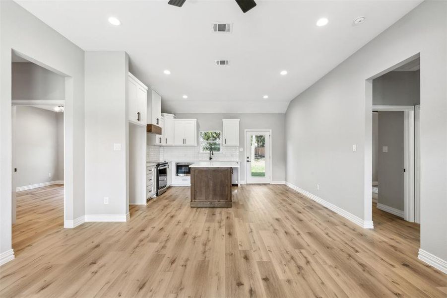 Unfurnished room with ceiling fan and light hardwood / wood-style flooring