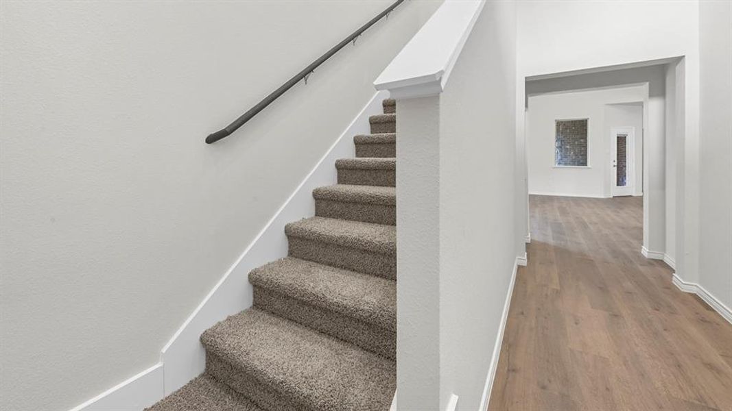 Stairs featuring baseboards and wood finished floors