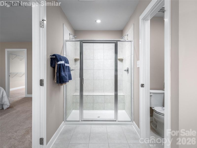 Optional Roman shower with built-in seat and dual shower heads — a spa-like experience right at home.