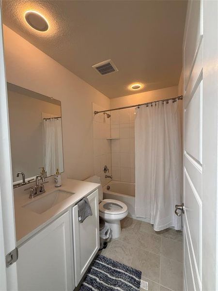Full bathroom featuring a white vanity with an integrated sink, brushed nickel faucet, and a large wall-mounted mirror