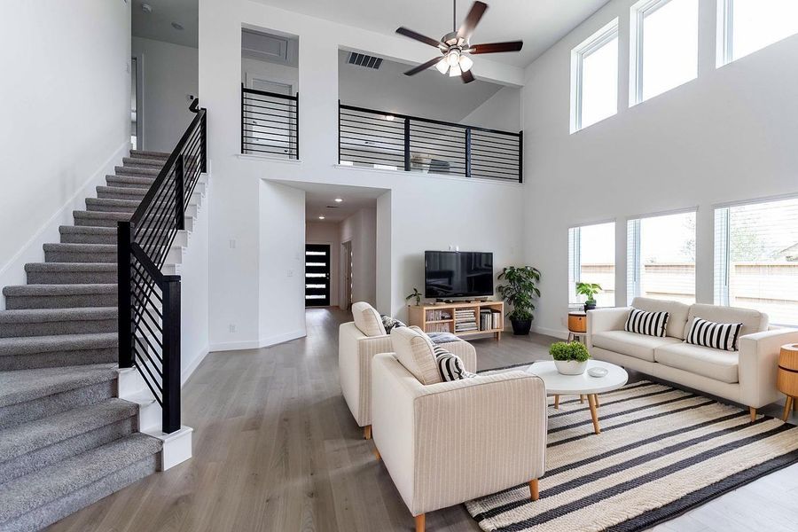 Wait till you greet your family and friends in this home! Lake lot!   Modern wrought iron railing lines the sweeping staircase that curves gracefully from the main living space, drawing your eye upward and adding a sophisticated touch to the home’s open design. **Image Representative of Plan Only and May Vary as Built**.