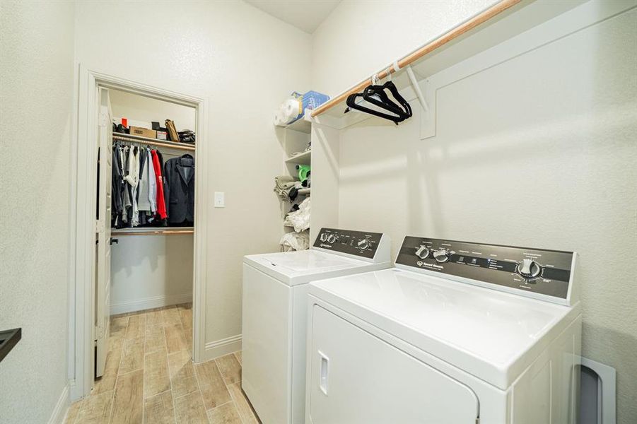 Laundry room with wood finish floors and separate washer and dryer Laundry room with wood finish floors and separate washer and dryer