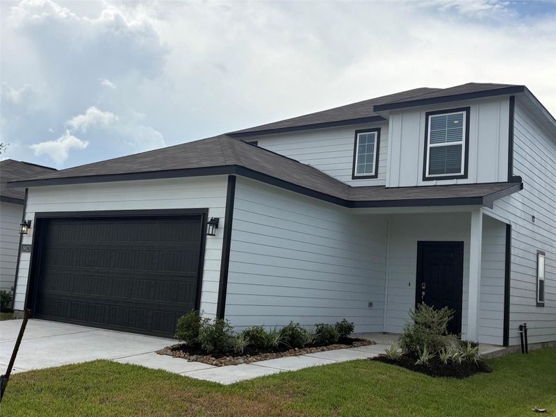 Front exterior of a new home in Northpark South, Porter, TX, highlighting curb appeal (Image 2). Front exterior of a new home in Northpark South, Porter, TX, highlighting curb appeal (Image 2).