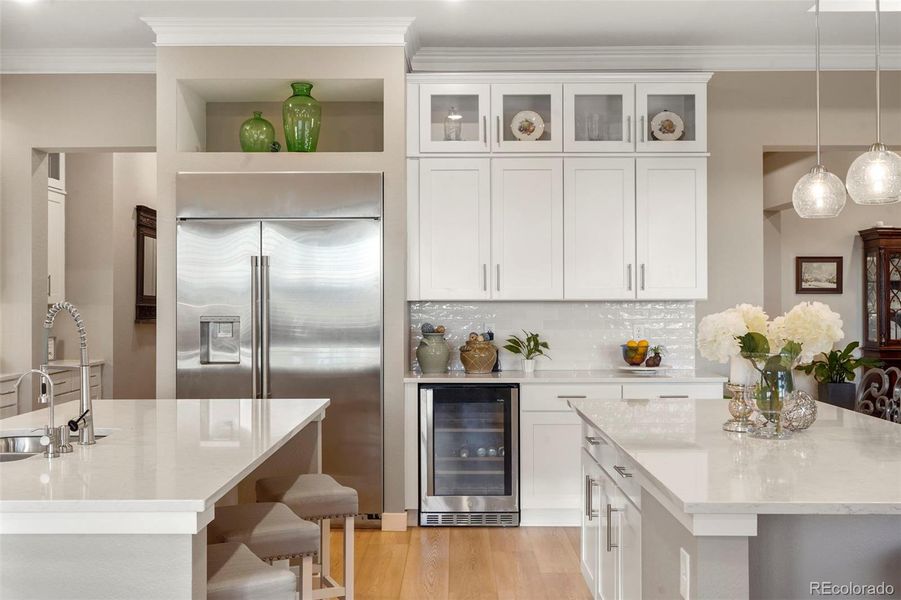 So many upgrades in this stunning kitchen. The dual quartz islands, double stacked cabinetry and stainless appliances make this kitchen a true showpiece