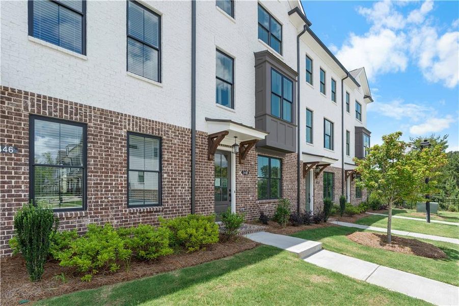 Exterior details and patio area of a home in Millcroft Townhomes, Buford (Image 1).