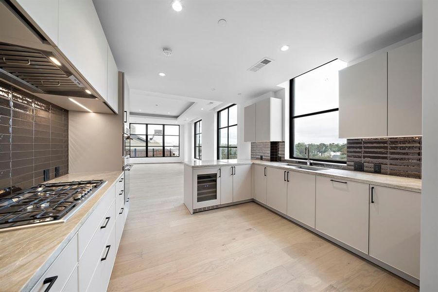 Abundant under cabinet lighting illuminates the generous counter space. A picturesque window offers serene views.