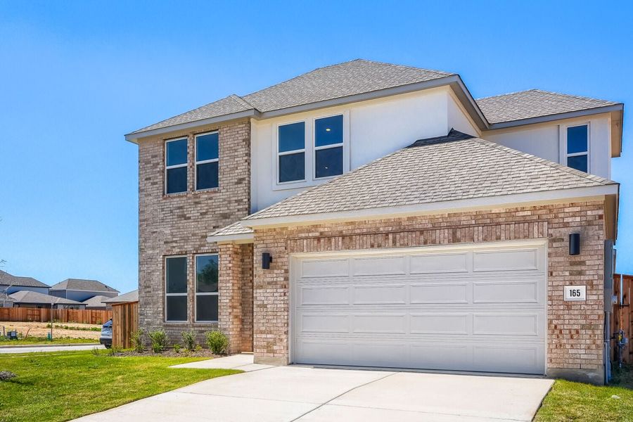 Front exterior of a new home in Freedom at Anthem, Kyle, TX, highlighting curb appeal (Image 2). Front exterior of a new home in Freedom at Anthem, Kyle, TX, highlighting curb appeal (Image 2).