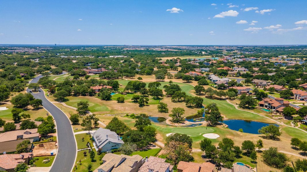 Aerial view featuring a water view, view of golf course, and a residential view