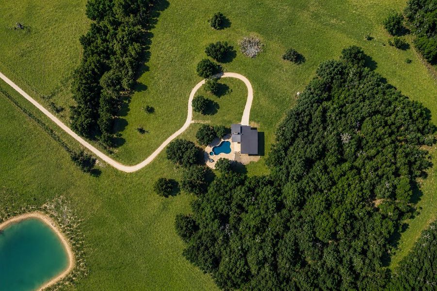 Aerial featuring an AI private pool, nestled amongst dense woodland and AI-enhanced open green fields. Aerial featuring an AI private pool, nestled amongst dense woodland and AI-enhanced open green fields.