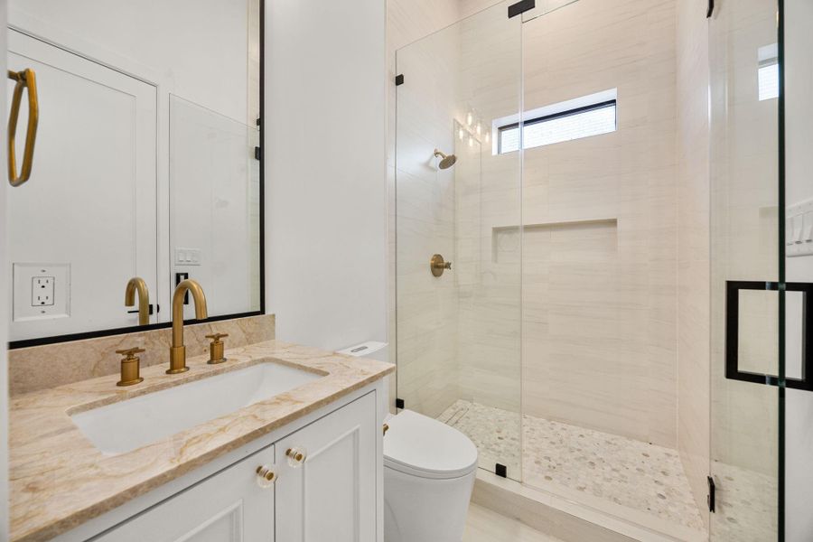 Secondary bathroom on 1st floor offers a glass encased walk-in shower. Secondary bathroom on 1st floor offers a glass encased walk-in shower.