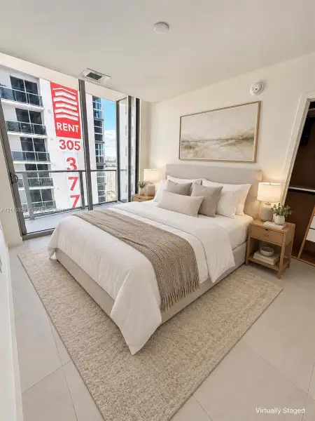Floor-to-ceiling glass windows, neutral-toned large format tile flooring, and a walk-in closet with built-in shelving