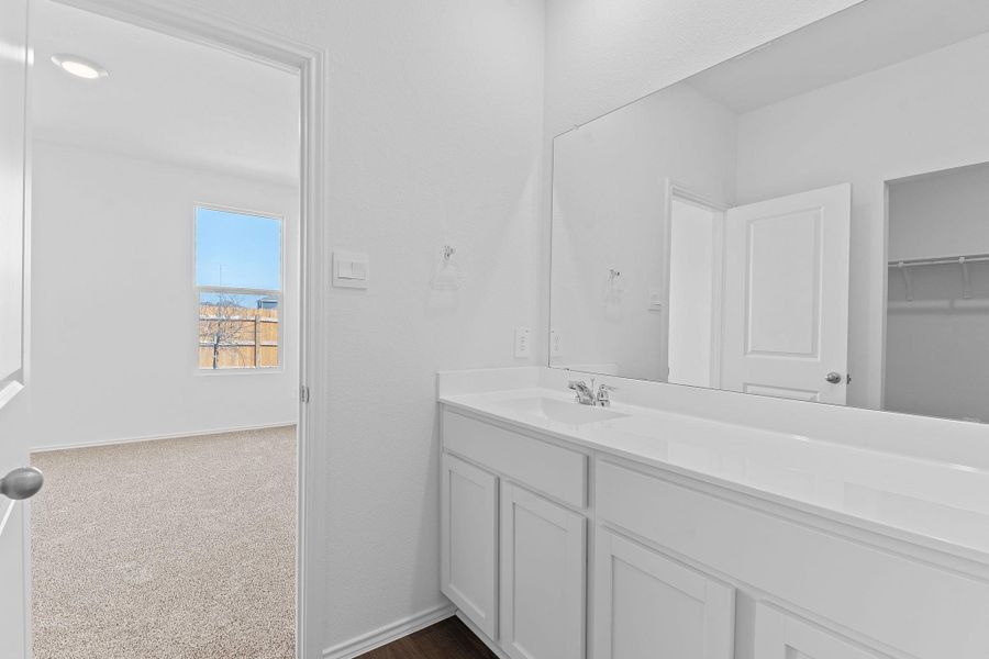 Bathroom with vanity and baseboards