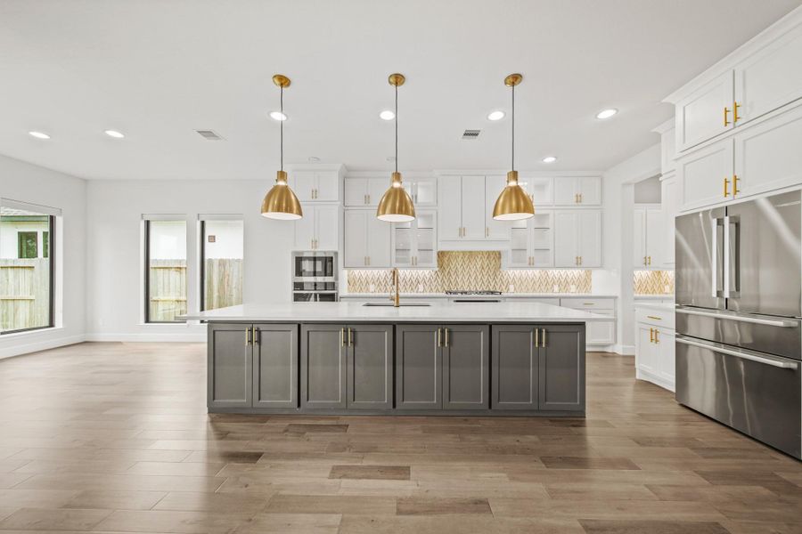 Elegant pendant lights and backsplash complement this beautiful kitchen Elegant pendant lights and backsplash complement this beautiful kitchen