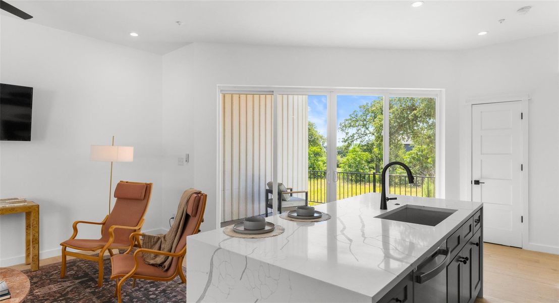 Quartz counters and a generous island make the kitchen as beautiful as it is functional — the natural heart of the home. Model No. 105 Shown.