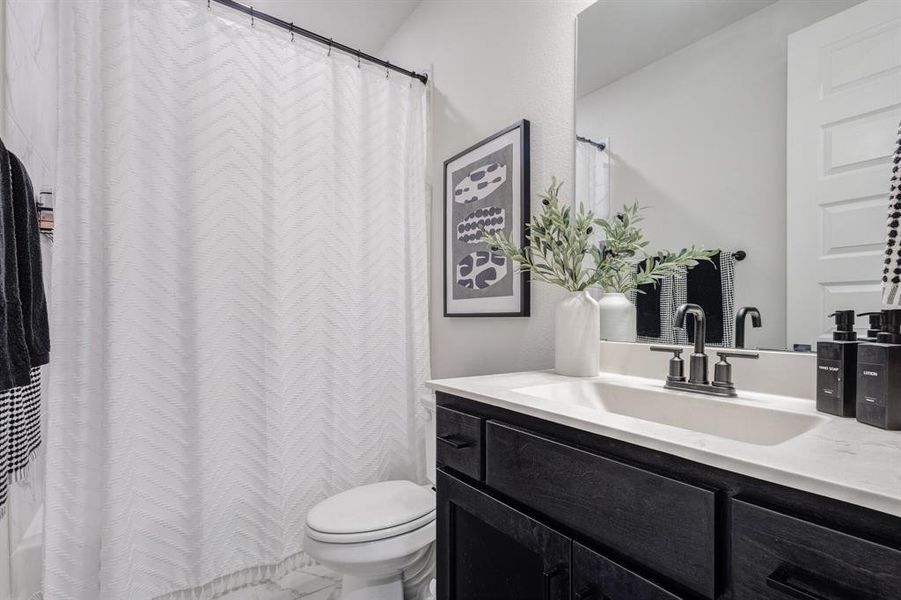 Full bathroom featuring vanity and curtained shower