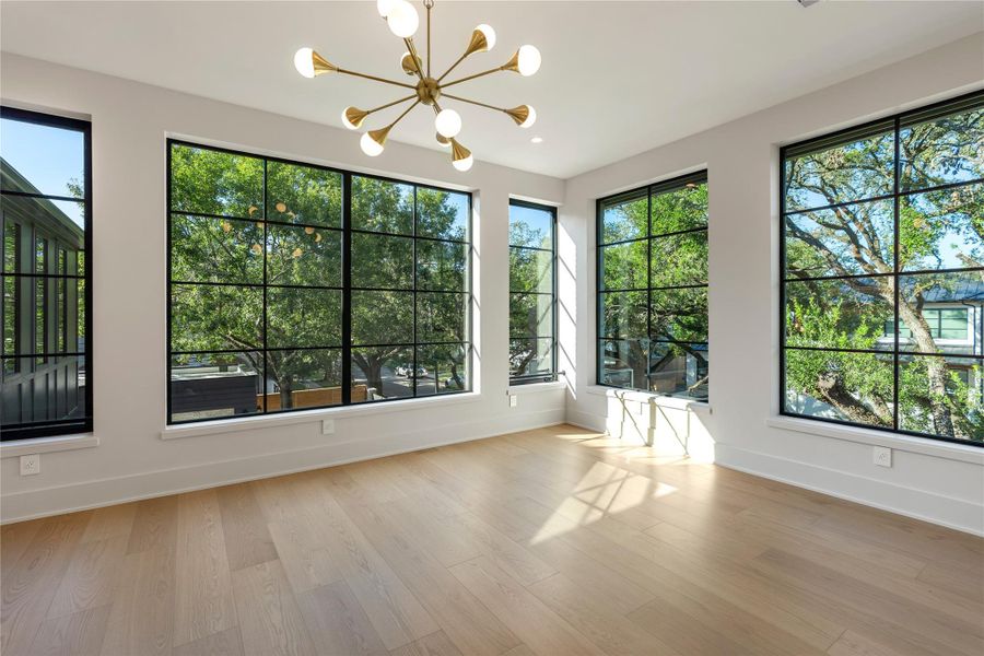 Ulta large multi-purpose room to meet your lifestyle with two walls of windows looking onto the oak tree canopy: media room, home office, art studio, exercise room, study/game room for children.  NOTE: This photo is a rendering of one of the builder’s prior homes and similarly used as an example for this home. Please contact the listing agent to tour this property and for more detailed information.