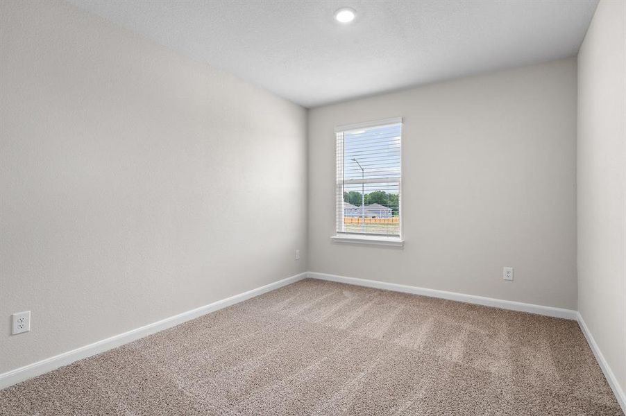 Spare room featuring carpet floors and baseboards Spare room featuring carpet floors and baseboards