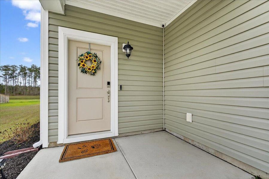 Exterior details and patio area of a home in Jasmine Point at Lakes of Cane Bay, Summerville (Image 3).