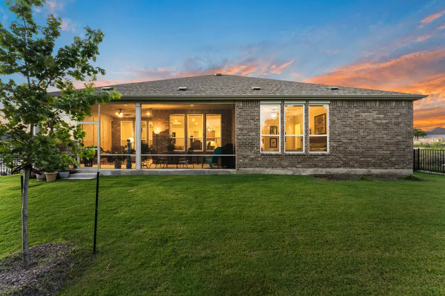 Excellent view of the back of the home and covered patio. Excellent view of the back of the home and covered patio.