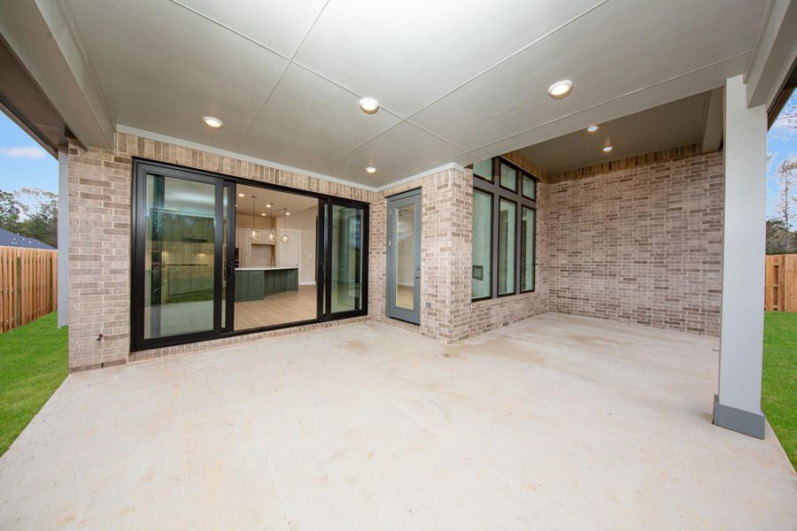 Step outside to the covered rear patio, the perfect extension of your indoor living space for year-round enjoyment. The greatest feature is the expansive black-frame multi-slide patio doors!