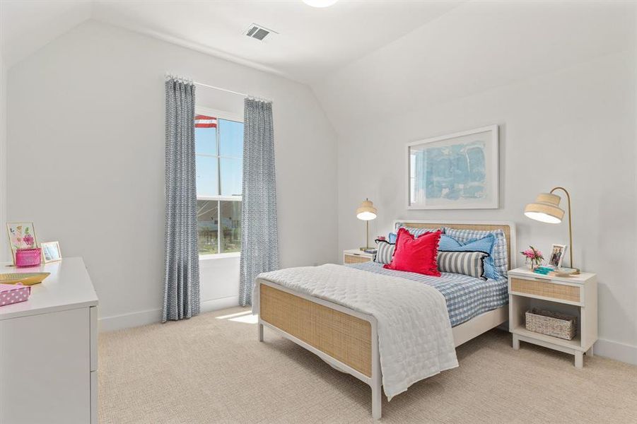 Bedroom with lofted ceiling and light colored carpet Bedroom with lofted ceiling and light colored carpet