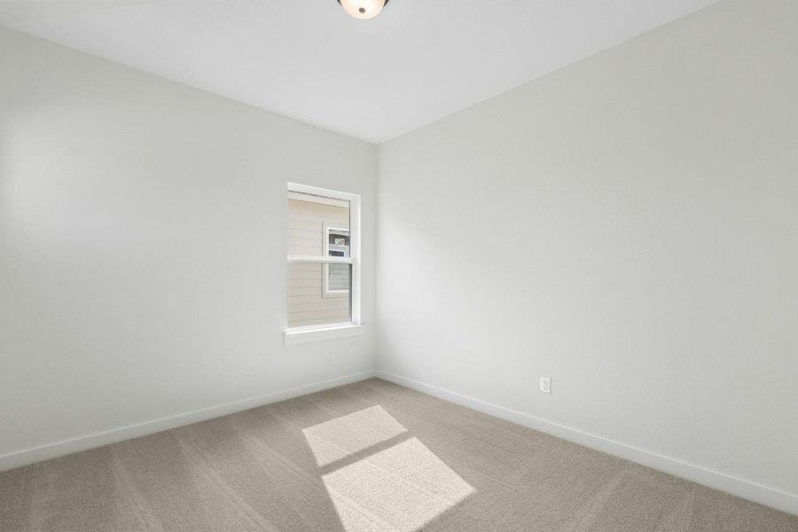 Empty room featuring carpet flooring and baseboards