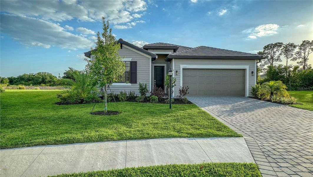 Front exterior of a new home in Lorraine Lakes at Lakewood Ranch, Lakewood Ranch, FL, highlighting curb appeal (Image 2).