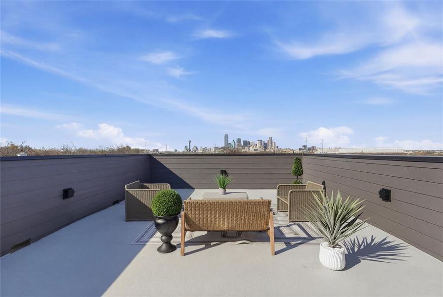View of patio with a view of skyline and outdoor seating