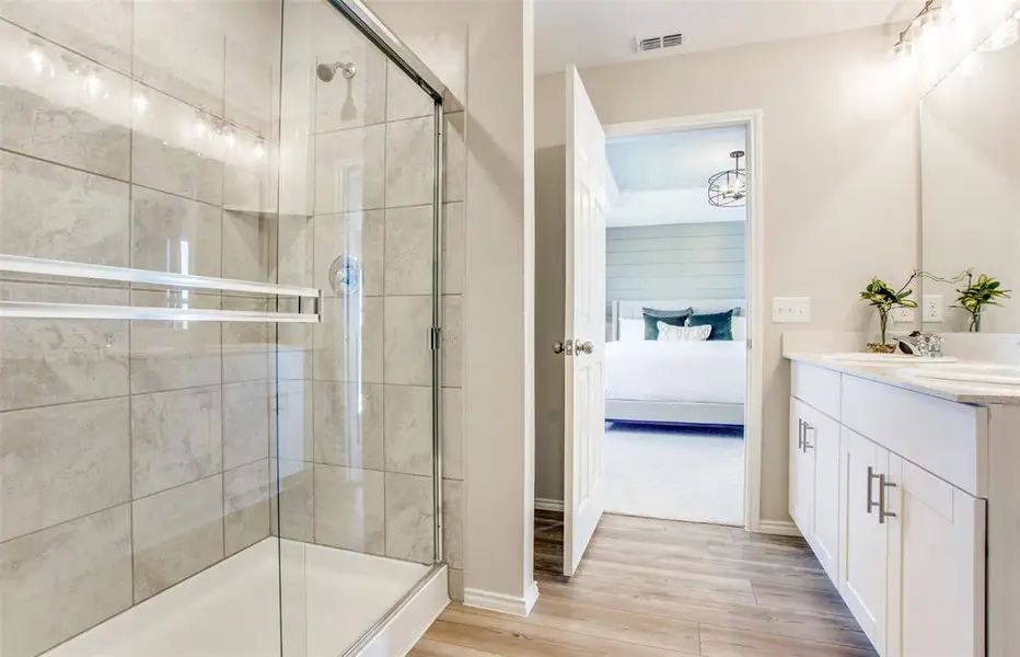 Owner's bath with double vanity and spacious shower *Model representation