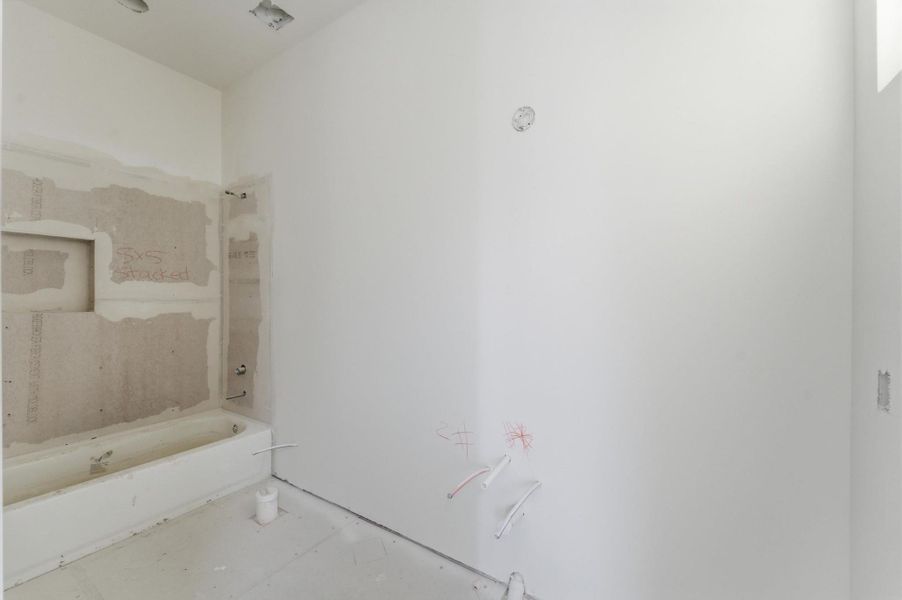 The second ensuite bathroom will have a tub/shower combo, quartz countertops and shaker cabinets.