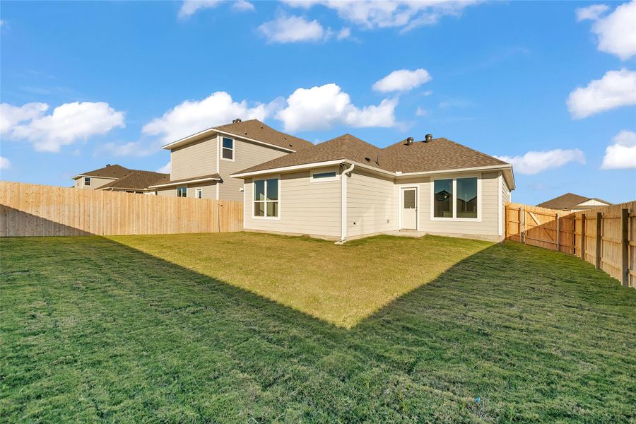 Back of house featuring a fenced backyard