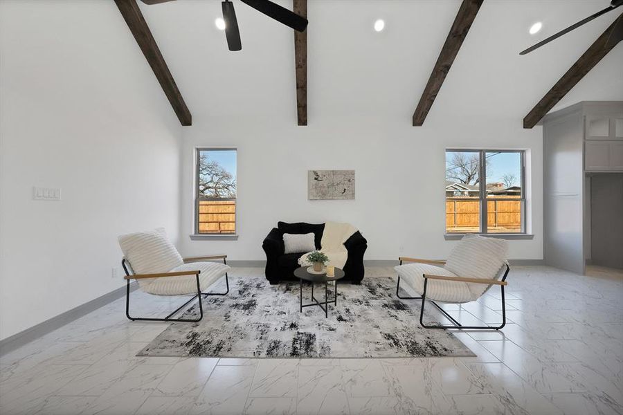 Living area with a ceiling fan, light marble finish floors, and recessed lighting