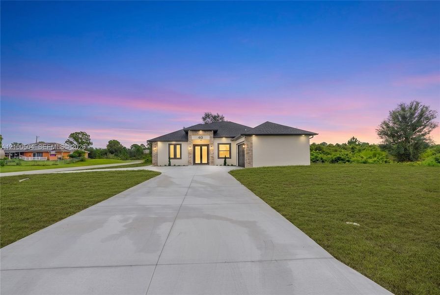 Front exterior of a new home in , Lehigh Acres, FL, highlighting curb appeal (Image 2). Front exterior of a new home in , Lehigh Acres, FL, highlighting curb appeal (Image 2).