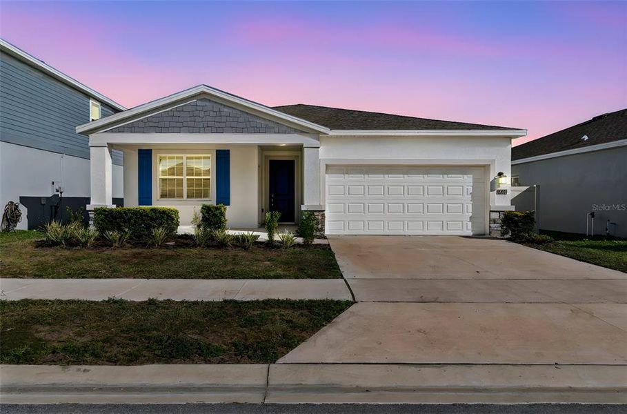 Front exterior of a new home in Ranches at Lake McLeod, Eagle Lake, FL, highlighting curb appeal (Image 29).